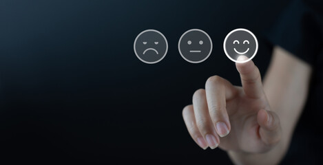 Customer service evaluation concept.Woman pressing smile face emoticon on virtual touch screen with copy space, minimalism