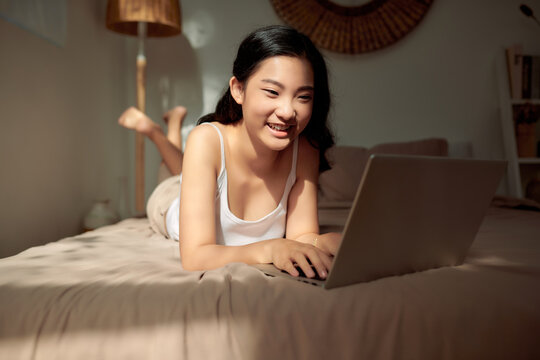 Woman Working Behind Laptop In The House.