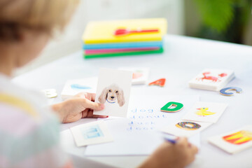 Kid learning to read. Phonics flash cards.