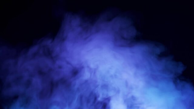 Mystical blue smoke on a black background. Dense clouds of steam in multi-colored lighting. Close-up, 4K UHD.