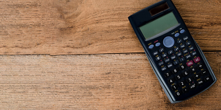 calculator on wood background,copy space.