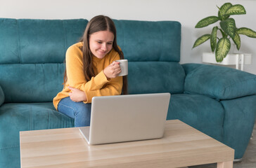 girl making a video call on the sofa