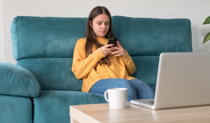 girl typing on the sofa