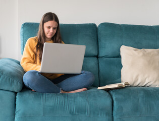 girl chatting with the laptop on the sofa