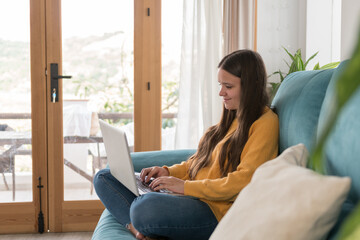 girl chatting with the laptop on the sofa