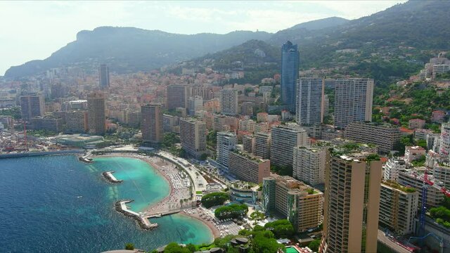 Monte Carlo, Monaco. Aerial view of famous city towering over Mediterranean Sea, modern high-rise buildings, Les Plages beaches  - landscape panorama of Europe from above