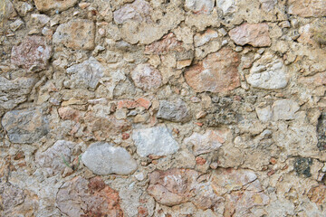 The surface of an ancient fortress wall made of stones