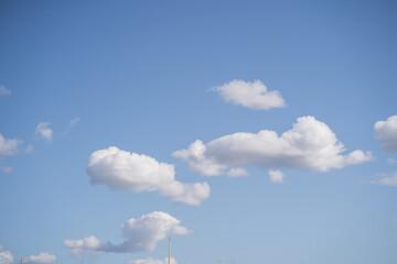 Clear blue sky. White air clouds in the blue sky. Sunny sky for the background.