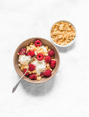 Homemade homemade ice cream with raspberries and sugar crumb cookies on a light background, top view