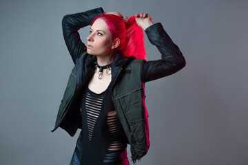 Futuristic fashion, a young bright and attractive woman with pink hair,