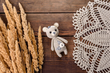 Toy hare tied from woolen threads on a dark background