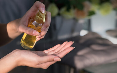 Woman's hand apply soap, gel, cream or hand cleansing sanitizer liquid, close up in natural lights. Hygiene and skin care. Infection prevention. Selective focus