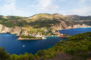 Fototapeta na wymiar Fantastic top view at Asos village, Assos peninsula and blue Ionian Sea water. Aerial view, summer scenery of famous and extremely popular travel destination in Cephalonia, Greece, Europe.