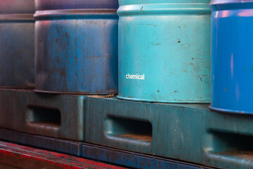 Blue metal chemical or gasoline fuel barrel drum, storage at the factory area. Industrial object...