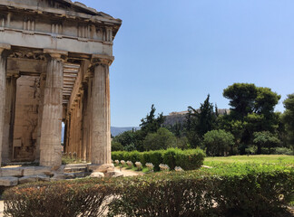 Doric colonnade at the Temple of Hephaestus or Hephaisteion, a well-preserved Greek temple that remains standing largely intact. The Acropolis can be seen in the background.