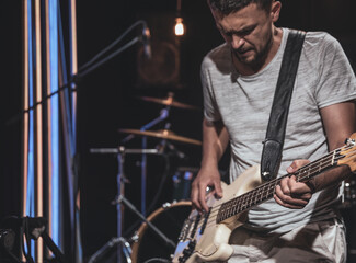 Musician with bass guitar during a performance.