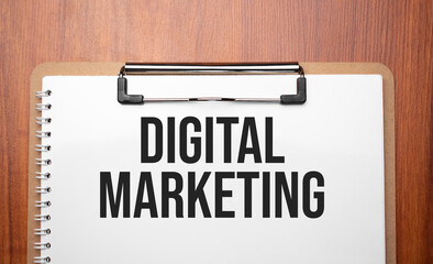 Digital marketing text on white paper on the wood table