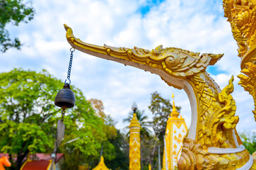 Fototapeta premium The beautiful golden swan (Hongsa) sculpture, a Thai style of sculpture decoration. Selective focus