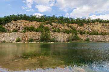 Fototapeta na wymiar Flooded quarry in the Czech Republic near the town of Mikulov in Europe. Beautiful landscape with a water surface.