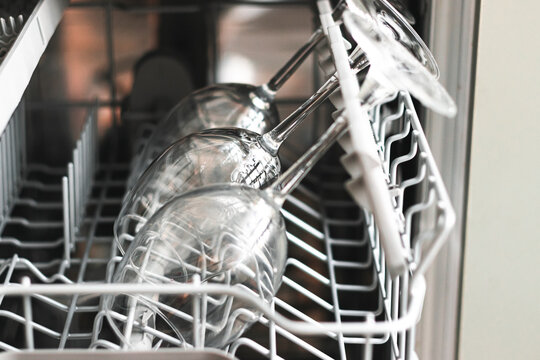 close up photo of raw wine glasses in a dishwasher. Cleaning concept.Selective focus for cleaning Wine glasses in dishwasher machine.