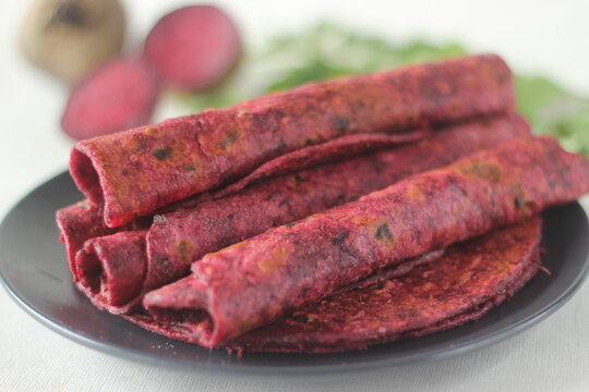 Beetroot Paratha is a Indian pan fried whole wheat flatbread made of wheat flour kneaded with fresh grated beetroot and spices.