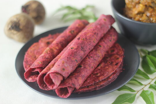 Beetroot Paratha is a Indian pan fried whole wheat flatbread made of wheat flour kneaded with fresh grated beetroot and spices. Served with chicken gravy curry.