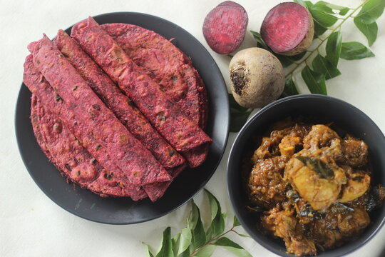 Beetroot Paratha is a Indian pan fried whole wheat flatbread made of wheat flour kneaded with fresh grated beetroot and spices. Served with chicken gravy curry.
