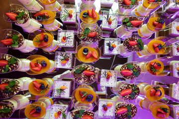 Fototapeta na wymiar Beautiful and bright desserts on the festive table for the party. Confectionery with cream