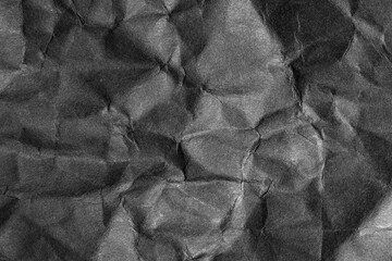 Abstract background of black crumpled paper.