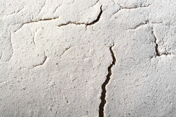 Cracks in the concrete screed. Abstract background.