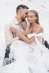 Naklejka premium Beautiful wedding couple bride and groom at wedding day outdoors at ocean beach. Happy marriage couple o