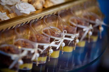 Beautiful and bright desserts on the festive table for the party. Confectionery with cream