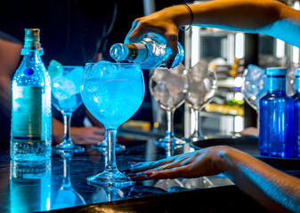 Close-up of the hands of a young woman preparing cocktails