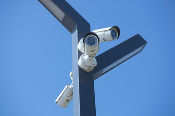Three CCTV Security camera on clear sky background