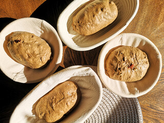 Four baskets with rye dough on the table