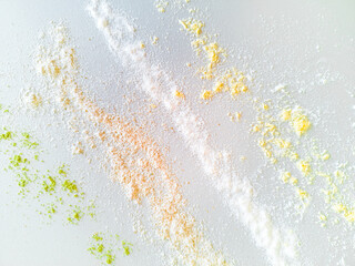 The texture of flour of different colors poured on the table