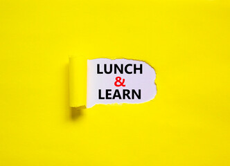 Lunch and learn symbol. Words 'Lunch and learn' appearing behind torn yellow paper. Beautiful yellow background. Business, educational and lunch and learn concept, copy space.
