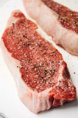 Raw cuts of seasoned flat iron steak