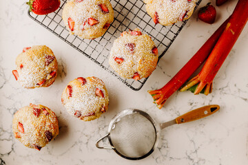 Strawberry Rhubarb muffins on tray dusted with powdered sugar