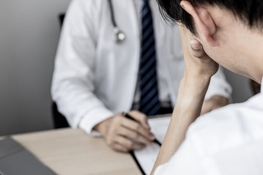 A male patient showed signs of stress after being diagnosed with a serious illness after attending an annual health check. Annual health check-up concept for timely treatment of disease.