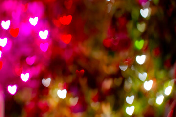 Christmas bokeh effect. Abstract background with heart shapes. Festive lights. Background. Banner. Out of focus. - obrazy, fototapety, plakaty