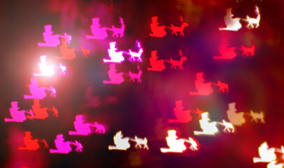 Christmas bokeh effect. Abstract background with shapes of Santa's sleigh with reindeer. Festive lights. Background. Banner. Out of focus.