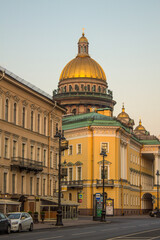 Obraz na płótnie Canvas Saint PETERSBURG, RUSSIA-July, 15, 2021: view of the historical buildings on Admiralteiskiy Prospekt and the golden dome of St. Isaac's Cathedral on a sunny summer morning