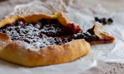 The pie is sprinkled with powder. Сurrant pie. Powdered sugar. Biscuit with currants. Tart with currants