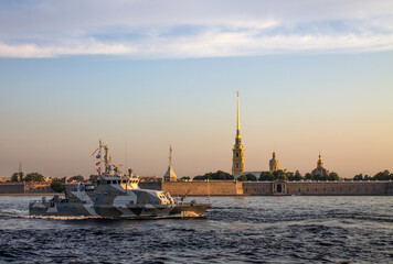 St. Petersburg, RUSSIA-July, 15, 2021: rehearsal of the parade on the Neva River in the early morning at dawn - a warship sails near the Peter and Paul Fortress