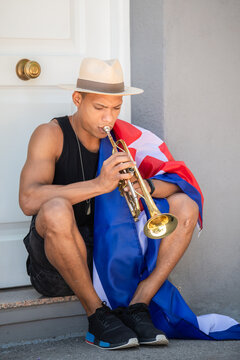 Close up of latino man with cuban flag playing the trumpet