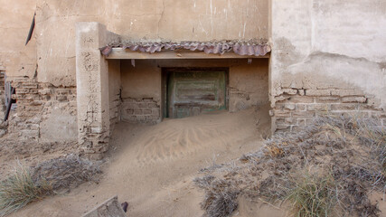 Sandcovered door entrance at the ghost town of Kolmanskop, Namibia