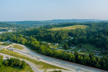 Fototapeta na wymiar Panoramic view of Dwight D. Eisenhower highway 70 road near small Bentleyville town hills the farm meadow in Pennsylvania, US