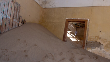 Doorway of one of the sandfilled housed at the ghost town of Kolmanskop, Namibia