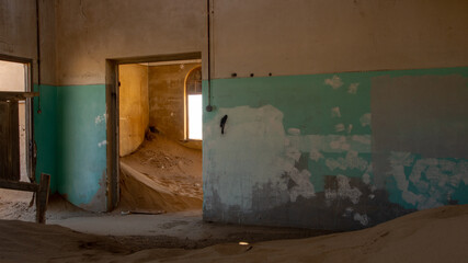 Doorway to sandfilled room at one of the houses in the ghost town of Kolmanskop, Namibia